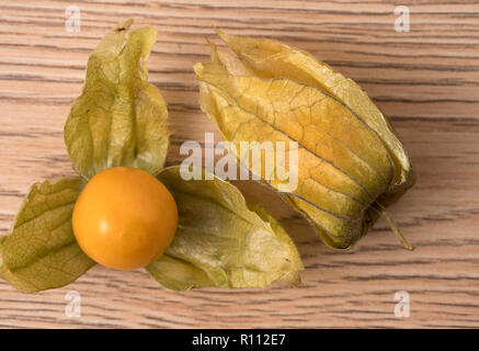 Physalis fruit (Physalis Peruviana) with husk on wooden background. Close up view. Stock Photo