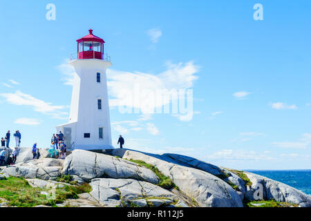 Peggys Cove, Canada - September 22, 2018: View of the lighthouse, with tourists, in the fishing village Peggys Cove, Nova Scotia, Canada Stock Photo