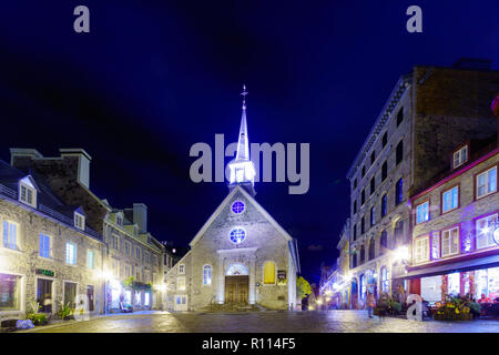 Quebec City, Canada - September 26, 2018: Night view of the Notre-Dame-des-Victoires Church with locals and visitors, in lower town of Quebec City, Qu Stock Photo