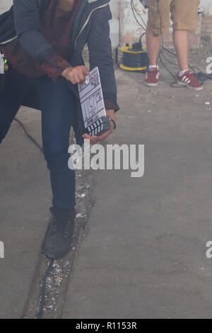 woman holding clapperboard Stock Photo