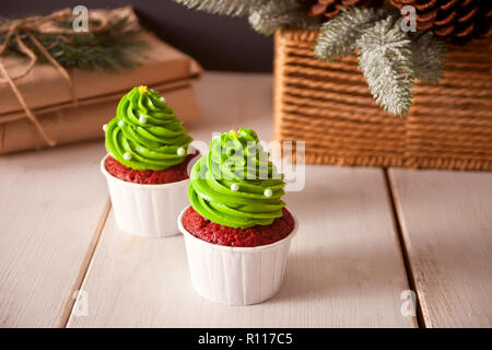 Cupcakes with green icing on the wooden table Stock Photo