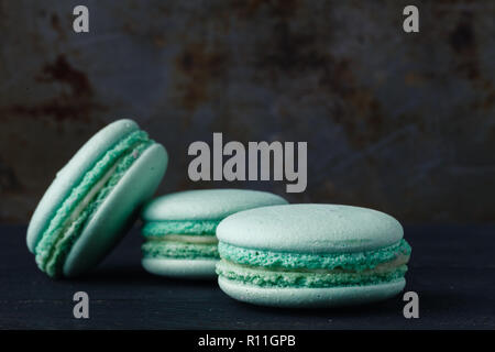 Blue french macaroons on rustic background Stock Photo