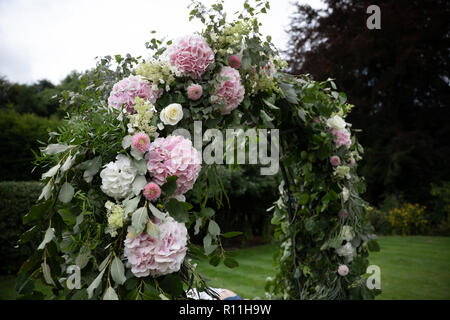 A floral flower arch at a wedding Stock Photo