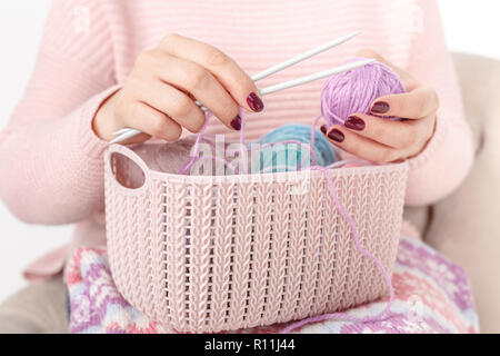 Woman knitting baby things in hand Stock Photo