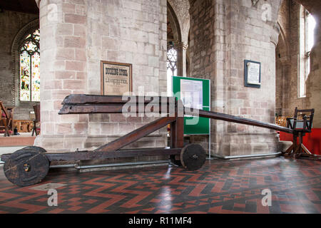 The Cucking Stool (sometimes also known as a Ducking Stool) on display in the Priory Church of St Peter & St Paul, Leominster. Stock Photo