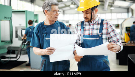 Team Of Engineers Having Discussion In Factory Stock Photo