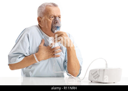 Elderly patient having chest pain and using an inhalator isolated on white background Stock Photo