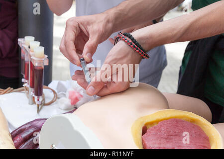 A student learning how to give an intramuscular injection Stock Photo