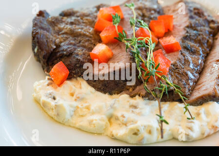 Beef fillet tagliata with vegetables on plate close Stock Photo