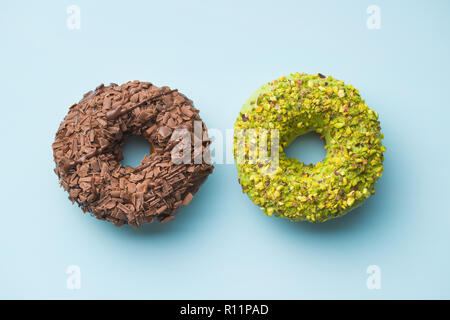 Sweet glazed donuts on blue background. Stock Photo