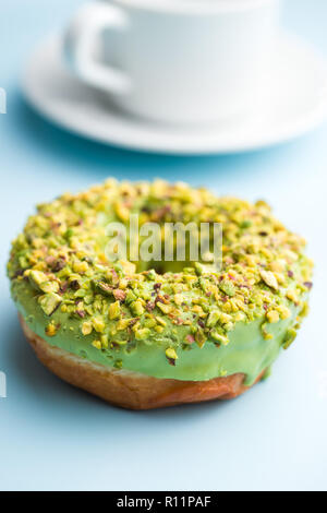 Sweet glazed donut on blue background. Stock Photo