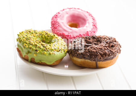 Three sweet donuts on plate. Stock Photo