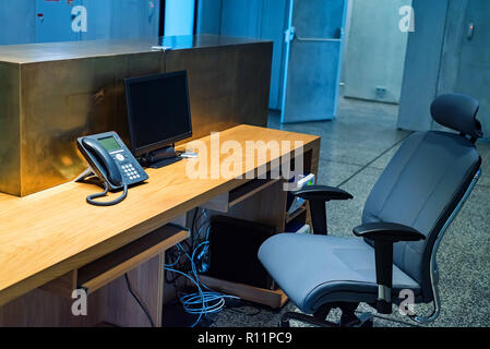 Reception desk, chair and telephone in modern business building Stock Photo