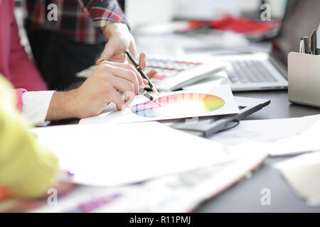 close up.designer working at office Desk with blueprints for a n Stock Photo