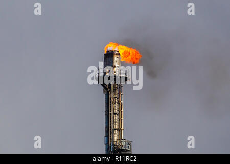 Refinery flare - Burning of dangerous gases in the oil field. Stock Photo