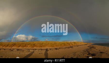 A full rainbow seen along the beach near Elie Fife Scotland. Stock Photo