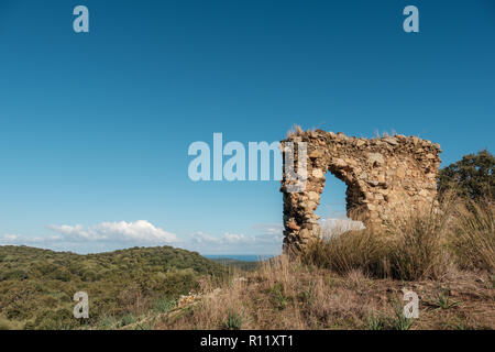 Reamins of an ancient stone building in the mountains of the Balagne region of Corsica with the Mediterranean in the distance Stock Photo