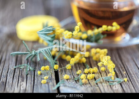 Spring flowers on rustic table with cup of tea Stock Photo