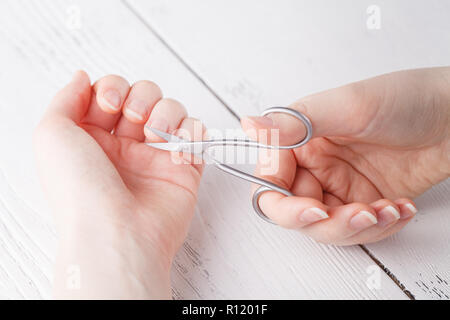 Health and personal care: Hand holding scissors for manicure Stock Photo