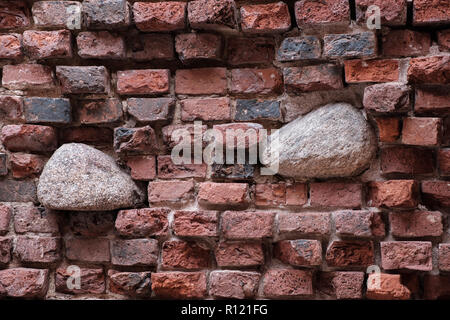 The wall of an ancient castle. Restored while preserving the destroyed elements of the wall to demonstrate the composition of the wall Stock Photo