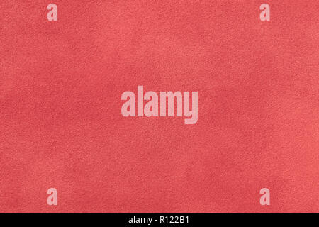 Coral matte background of suede fabric, closeup. Velvet texture of seamless red leather. Felt materisl macro. Stock Photo