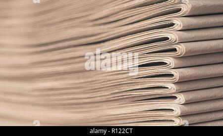 Stack of old newspapers - Soft focus with copy space. Stock Photo