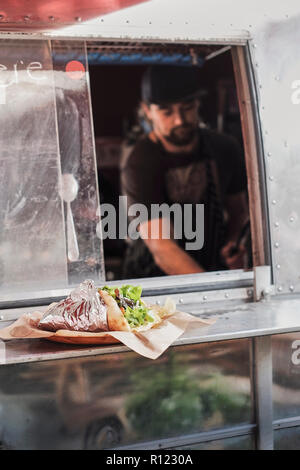 Man cooking in camper van food truck Stock Photo