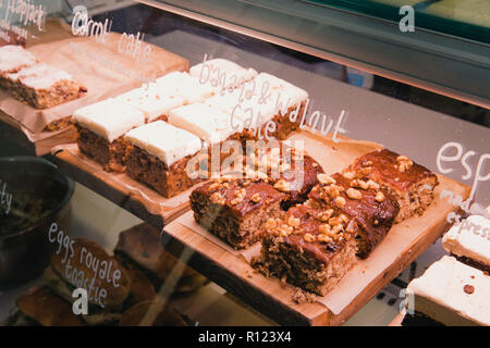 Selection of cakes in a coffee shops display unit. Stock Photo