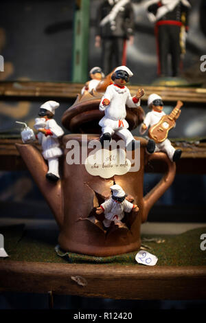 figure of Pulcinella, Neapolitan theatrical mask, with coffee pot with Neapolitan writing ,what a nice coffee, at the souvenir shop in Naples Stock Photo
