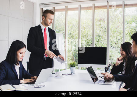 Market analysts person use laptop to planning and brain storming with marketing business people by looking at growth finance graph in office. Stock Photo