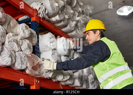 Young worker with scanner inspects the inventory in the warehouse Stock Photo