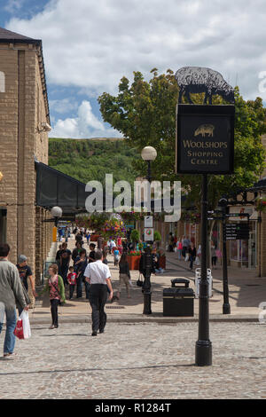 Sunny summer view of the sign and shops of the Woolshops shopping centre in the Yorkshire town of Halifax