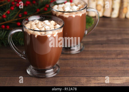 A Pair of Mugs Filled with Hot Chocolate and Marshmallows on a Wooden Table Stock Photo