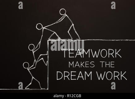Concept of a business team working together to accomplish their dream drawn with chalk on blackboard. Teamwork makes the dream work concept. Stock Photo