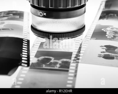 Loupe over film negatives Stock Photo