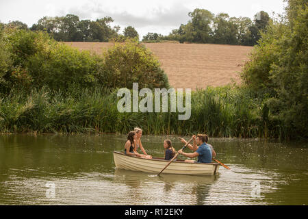 Friends on boat ride in lake Stock Photo