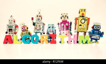 The word ALGORITHM  with wooden letters and retro robot toys on white Stock Photo