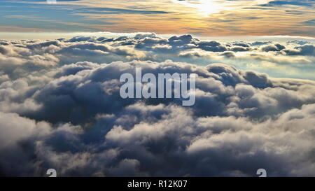 Above the clouds, paragliding in the autumn light of the November sun. Aerial perspective view of a powered paraglider. Stock Photo