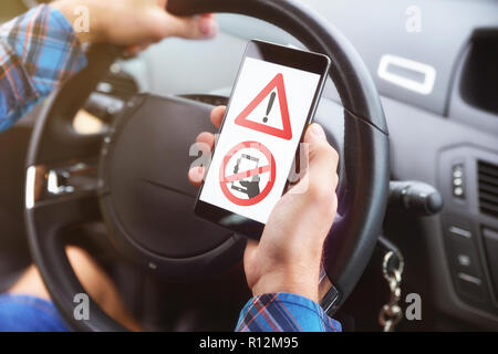 Concept of the danger of the use of the mobile telephone at the wheel. Stock Photo