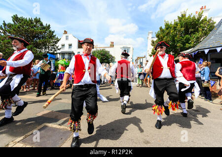 Broadstairs Folk week festival. Victory Morris men side, dressed as 18th century sailors, dancing on seafront promenade. Stock Photo
