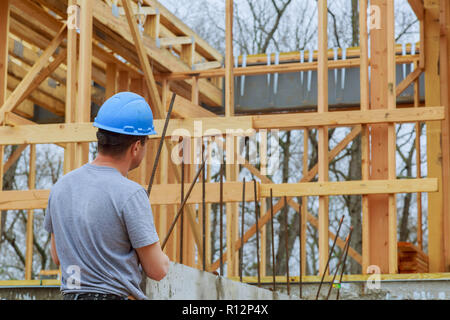 A building inspector surveys a new home build in construction site checking new building Stock Photo
