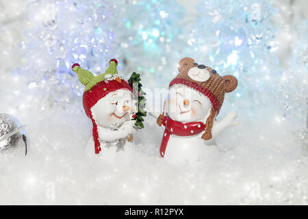 Couple of funny cute snowmens are enjoying Christmas surrounded by festive decorations Stock Photo