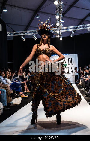 Beirut, Lebanon. 8th November, 2018. Model wearing a dress made from chocolate walks the runway at the Salon du Chocolat catwalk show in Beirut, Lebanon. These carefully designed garments have been painstaking put together by top Chocolatiers working with Lebanese fashion designers to create the perfect look for a carnival theme Credit: Elizabeth Fitt/Alamy Live News Stock Photo