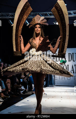 Beirut, Lebanon. 8th November, 2018. Model wearing a dress made from chocolate walks the runway at the Salon du Chocolat catwalk show in Beirut, Lebanon. These carefully designed garments have been painstaking put together by top Chocolatiers working with Lebanese fashion designers to create the perfect look for a carnival theme Credit: Elizabeth Fitt/Alamy Live News Stock Photo