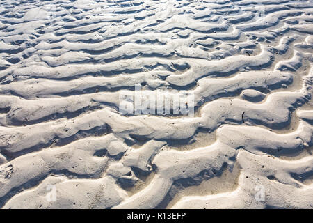 Sand texture from waves and wind. Stock Photo