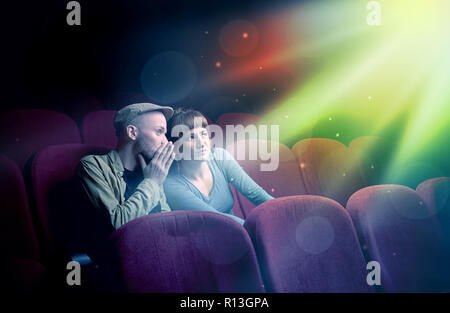 Teenager couple cuddling and watching the climax part of the movie Stock Photo