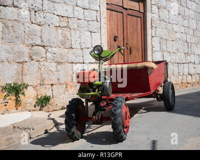 Old small tractor machine on stone streets of island Vis in Croatia Stock Photo