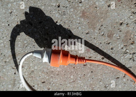 Extension cable and plug with two round pins, to connect electrical equipment. Stock Photo