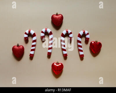 Christmas candy cane and hearts at studio above view over a brown background isolated flatlay Stock Photo