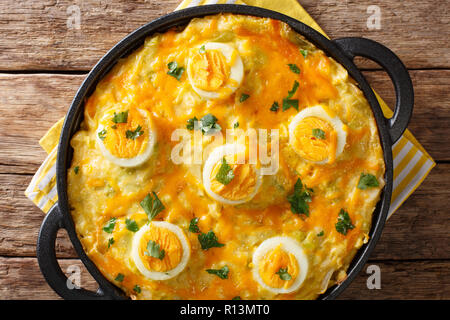 Welsh casserole Anglesey eggs baked with mashed potatoes, cheese sauce with leek close-up on the table. horizontal top view from above Stock Photo